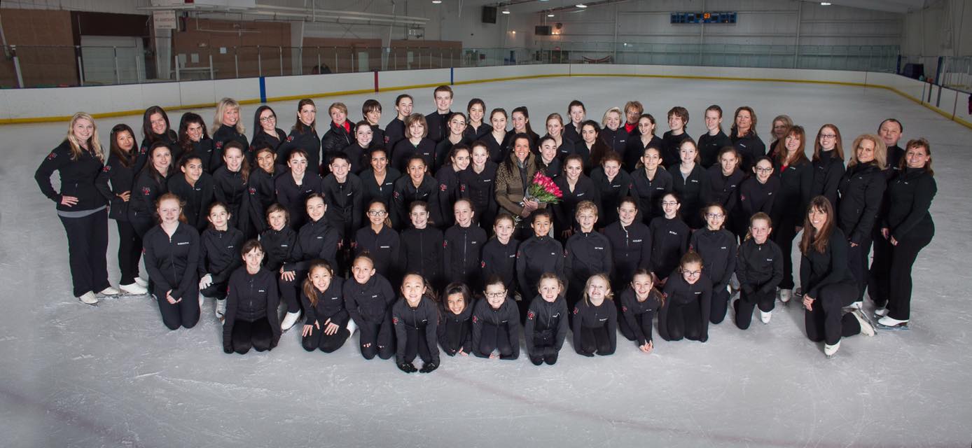 The entire Creative Ice Theatre Company dressed in the Creative Ice Theatre jacket and black pants.